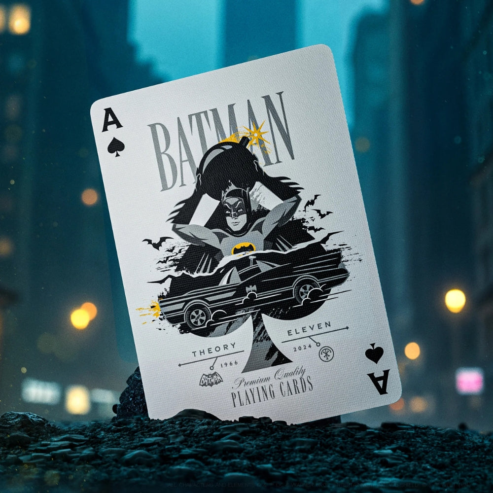 Ace of spades showing the classic adam west batman holding a bomb. This batman playing card is standing up in some rock, in the middle of a big city