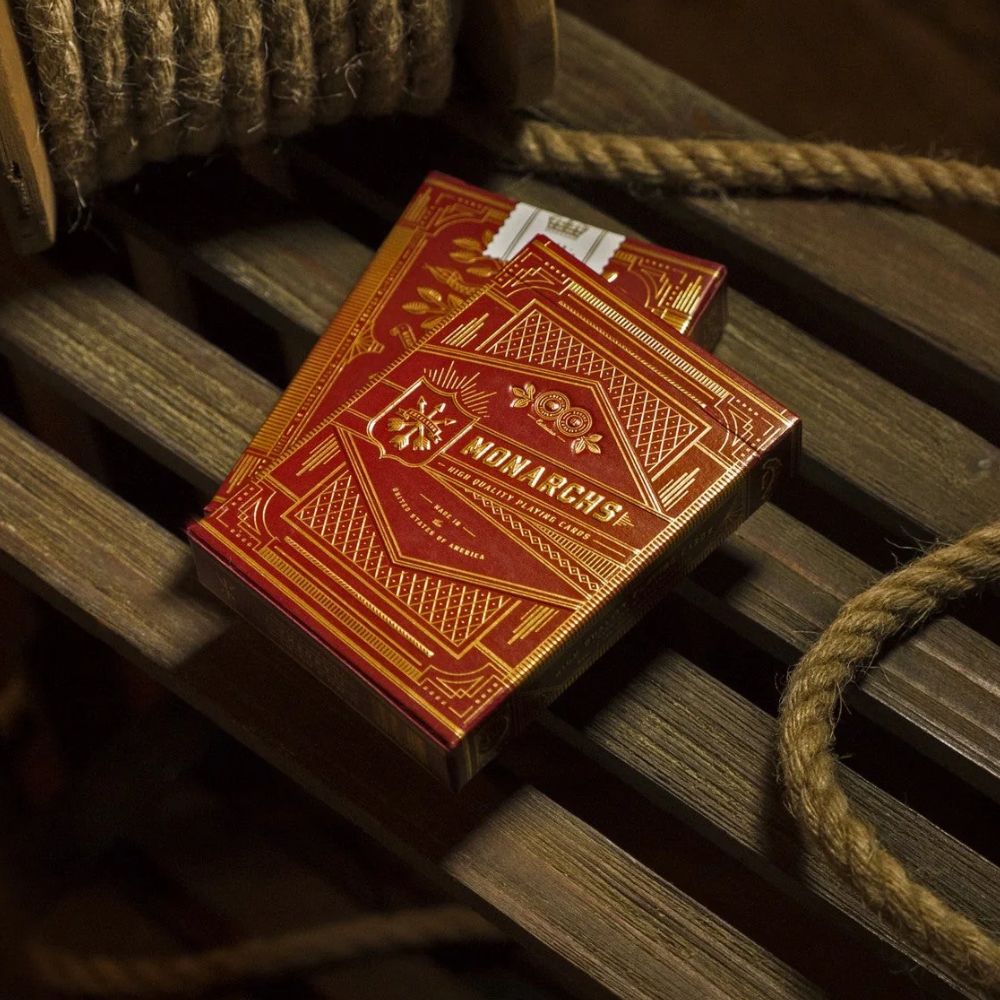 Monarch playing cards - Red edition - two deck boxes on a wooden slatted surface