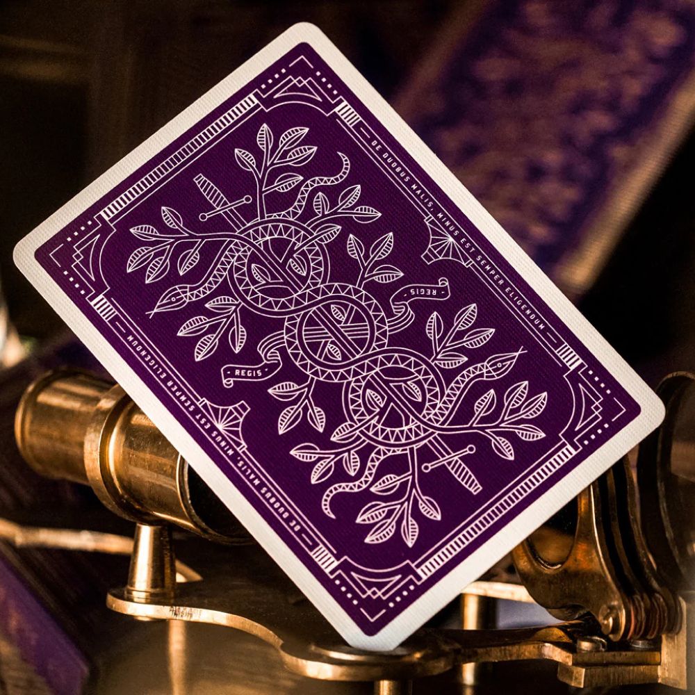 back of a purple monarch playing card leaning against some metal apparatus