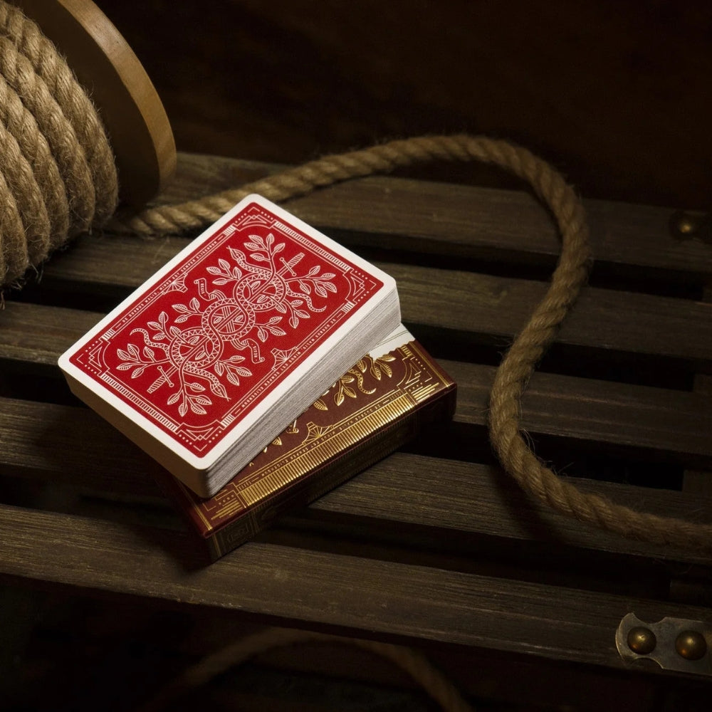 deck of face down red monarch playing cards, stacked on a deck box.
