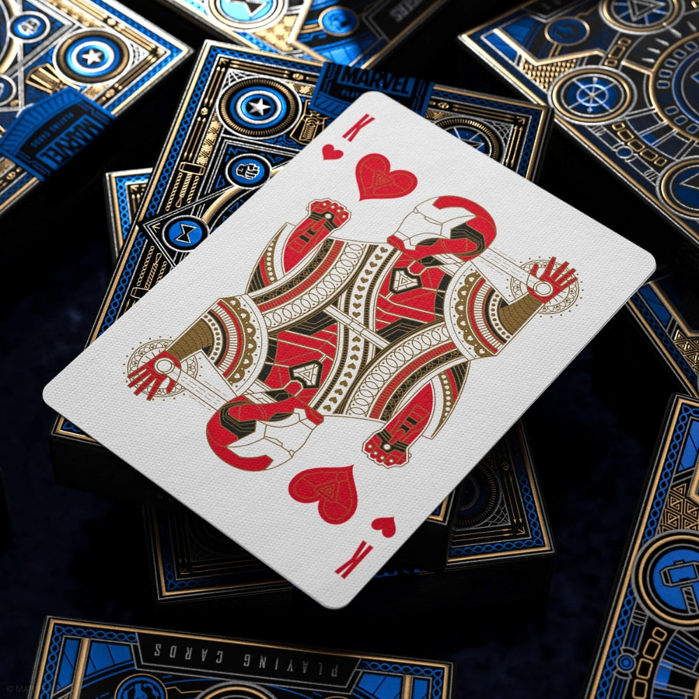 King of hearts from a set of avengers playing cards, laying on top of some blue deck boxes