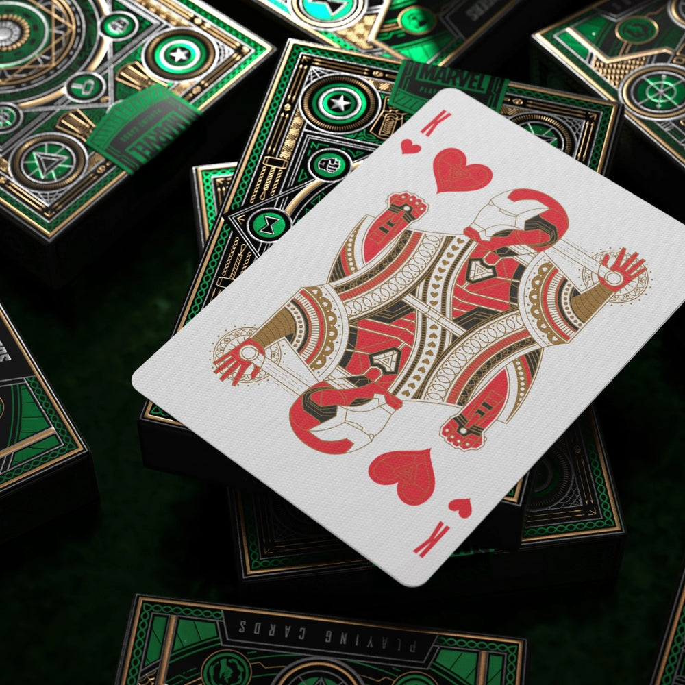 King of hearts from avengers playing cards, laying over a scattering of green deck boxes.