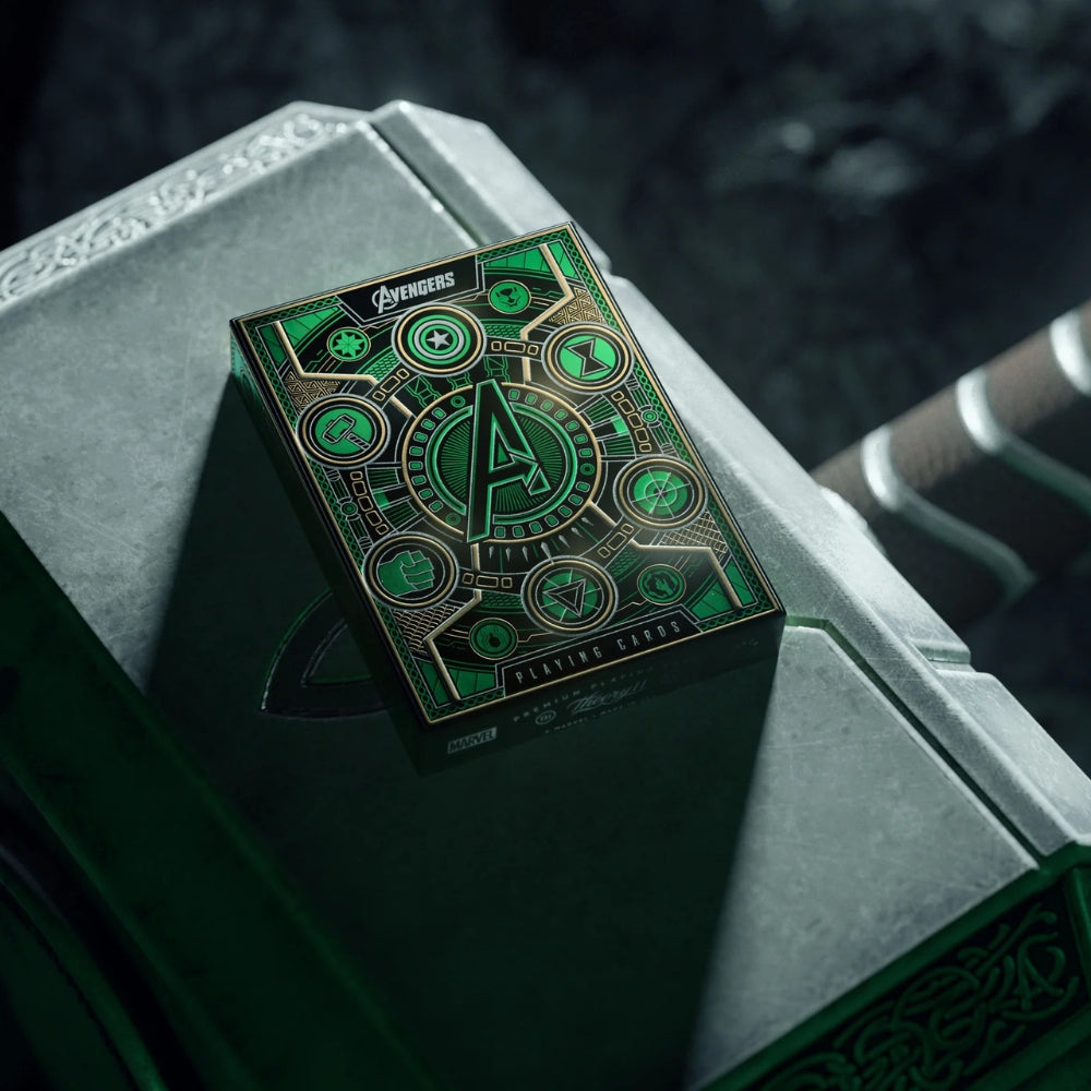 A pack of green avengers playing cards, resting on thors hammer.