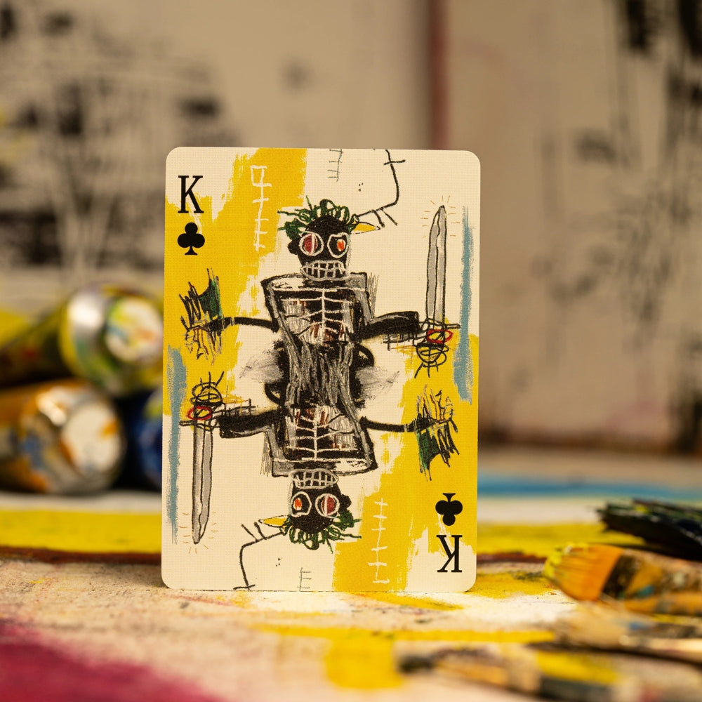 King of clubs from a deck of basquiat playing cards on a painting palette
