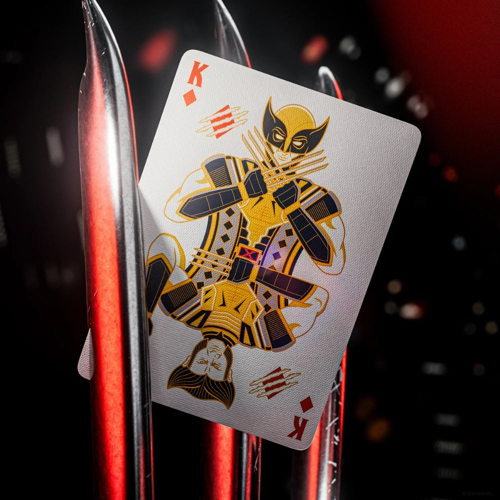 King of diamonds from a set of deadpool playing cards, made to look like its being held by wolverines blades
