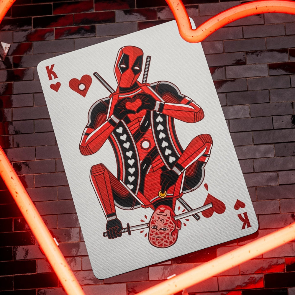 King of hearts from a set of deadpool playing cards, with parts of a neon heart in the picture