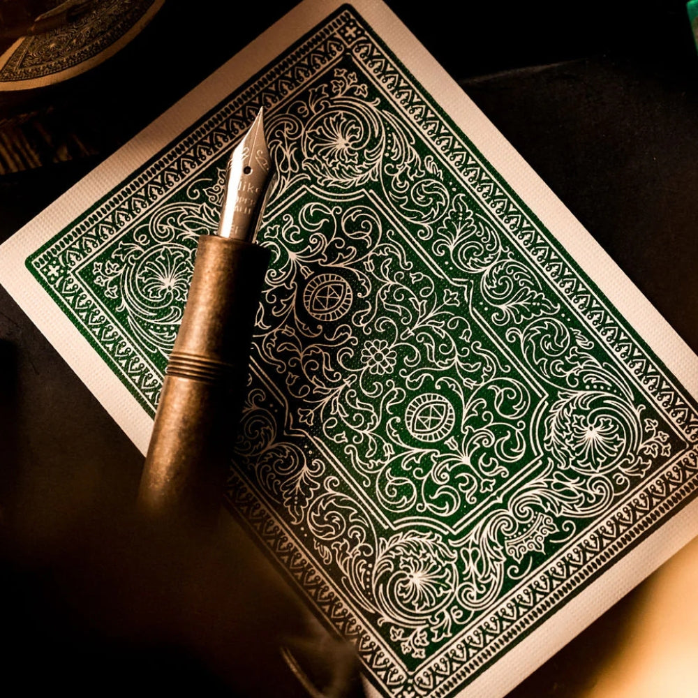 back of a playing card taken from a deck of Darren Brown playing cards, with a ornate fountain pen laying over the top
