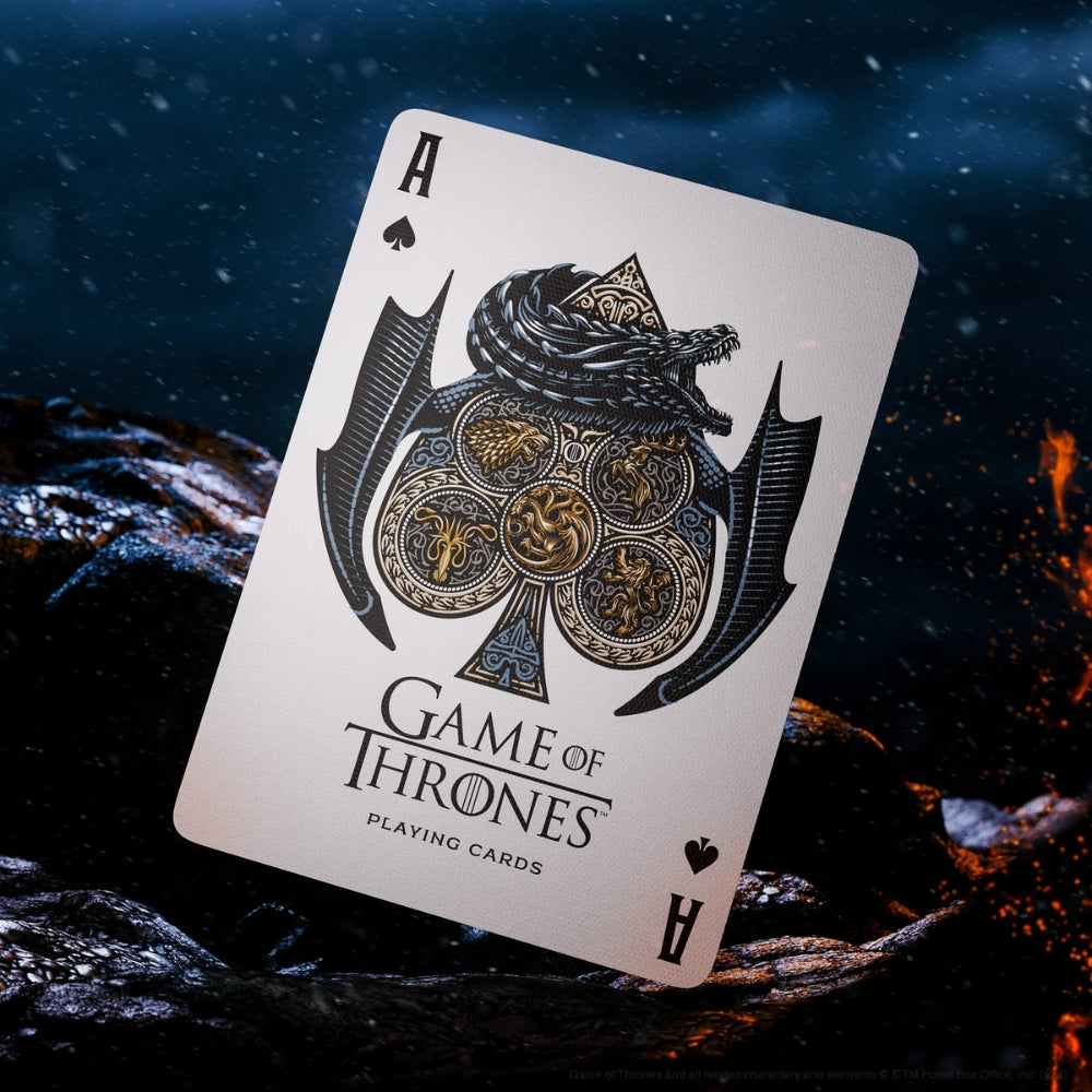 Ace of spades card from a set of Game of thrones playing cards, standing on black rock , with hints of fire, ice and snow