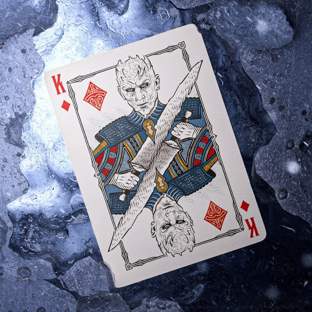 King of diamonds card, taken from a set of Game of throne playing cards, the card is laying on what looks like rock and ice