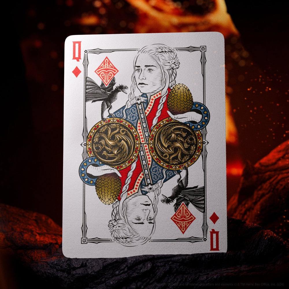 Queen of diamonds card, from a set of game of thrones playing cards, standing on a dark rock with larva in the background