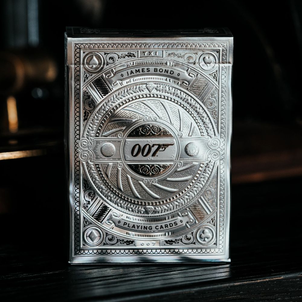 James bond playing cards, single silver deck box on dark wooden surface