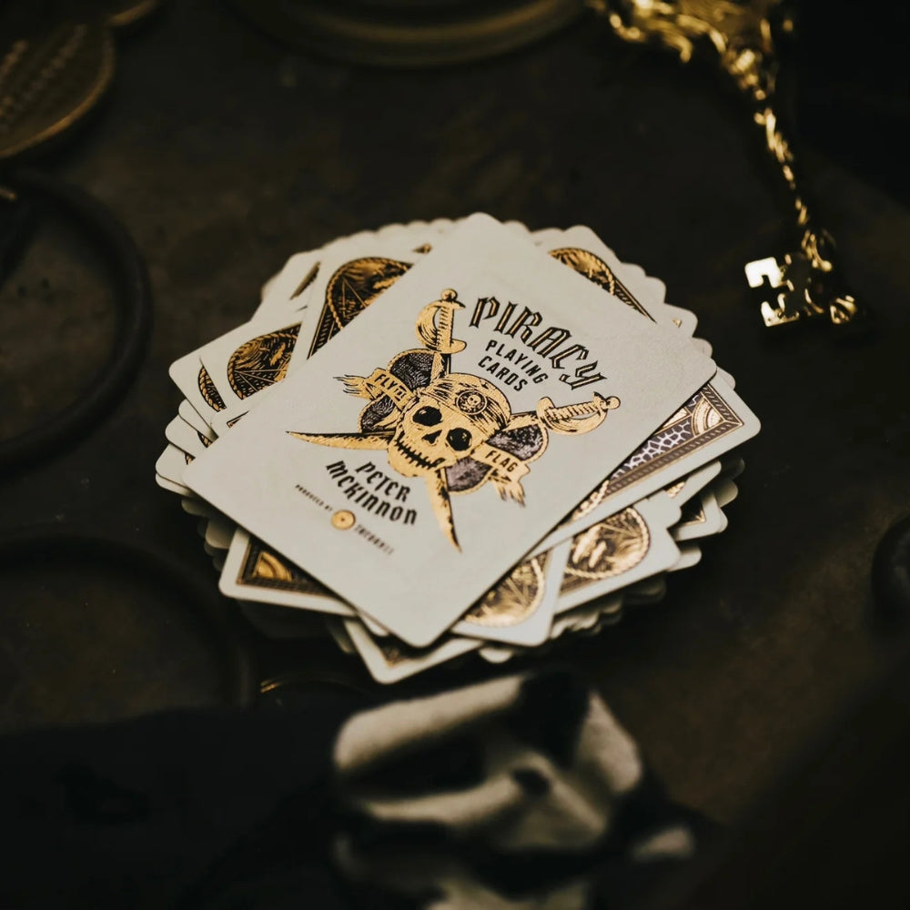 Joker card, laying on a deck of face down piracy playing cards