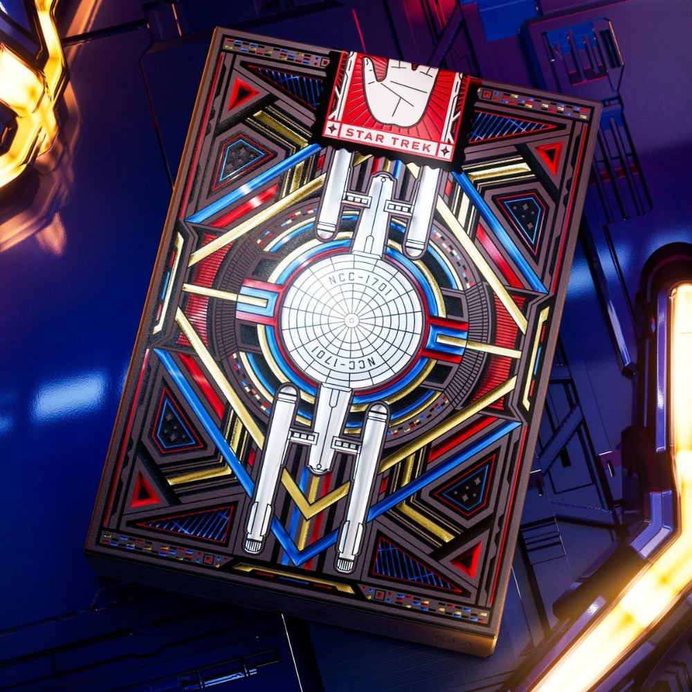 Closeup of a deck of star trek playing cards, the deck box is laying on a clean shiny metal surface with lights in the corners