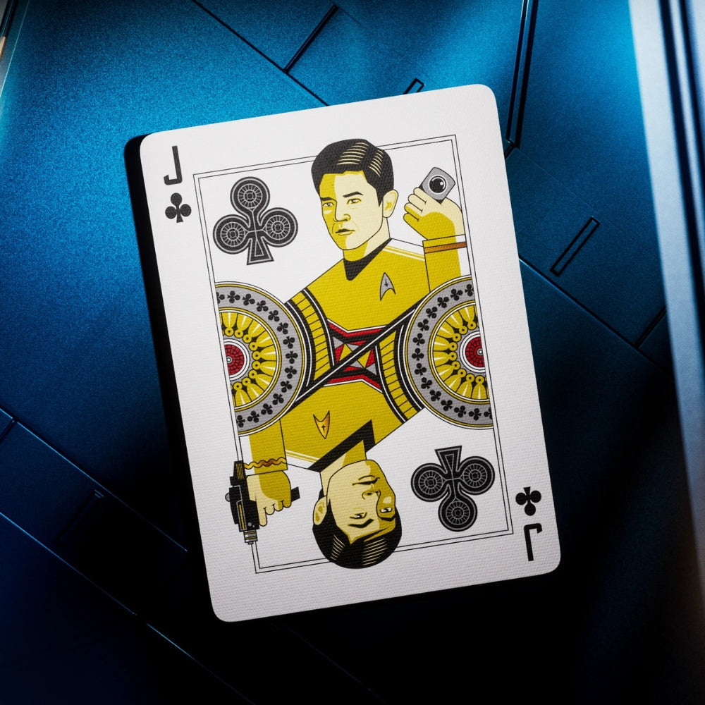 Jack of clubs, star trek playing card, laying on a blue hue metal surface