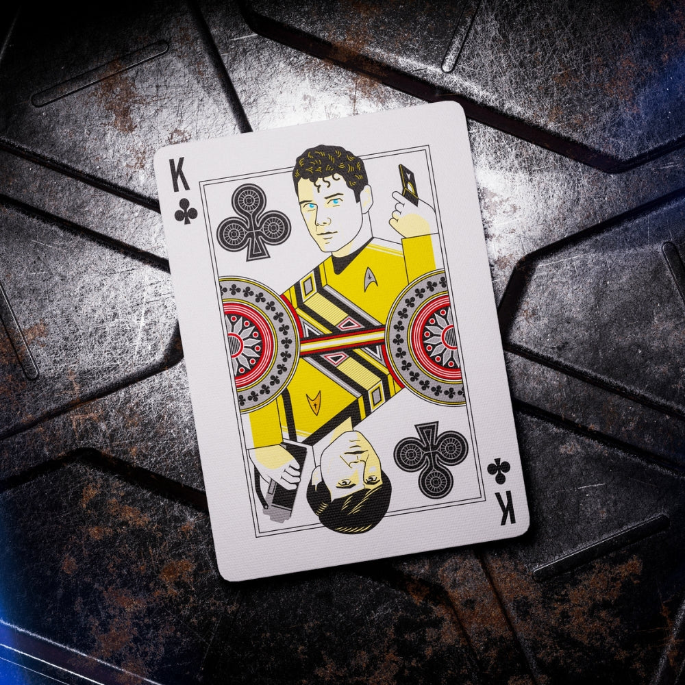 King of clubs taken from a set of Star trek playing cards, the card is laying on a beat up metal surface