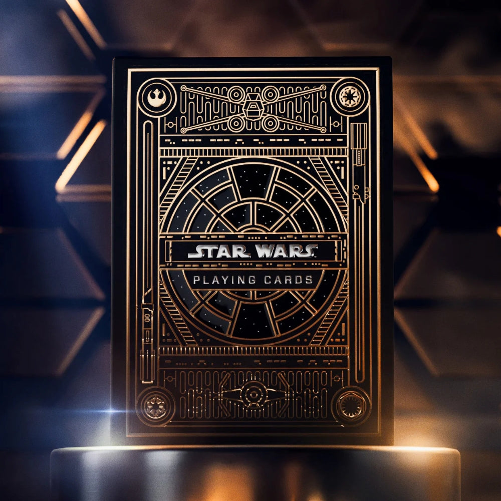 Deck of star wars playing cards, the deck box is black and gold and the background of the image matches this theme