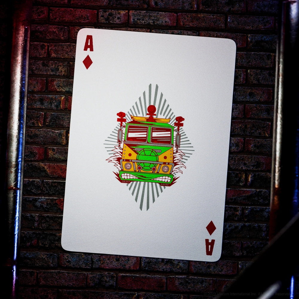 ace of diamonds from a set of teenage mutant ninja turtles playing cards, laying against a dirty brick wall