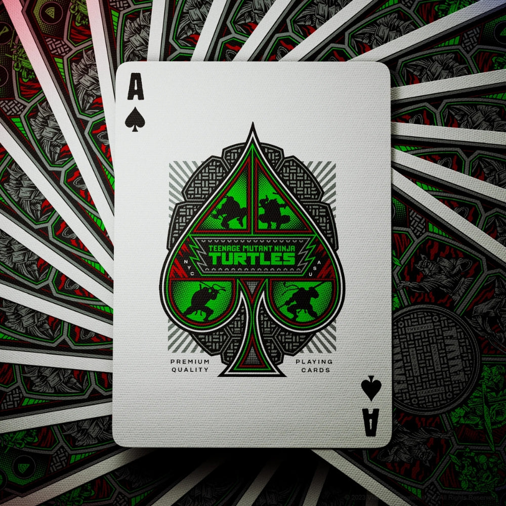 Ace of spades laying over a swirl of face down cards, all cards from a deck of teenage mutant ninja turtles playing cards
