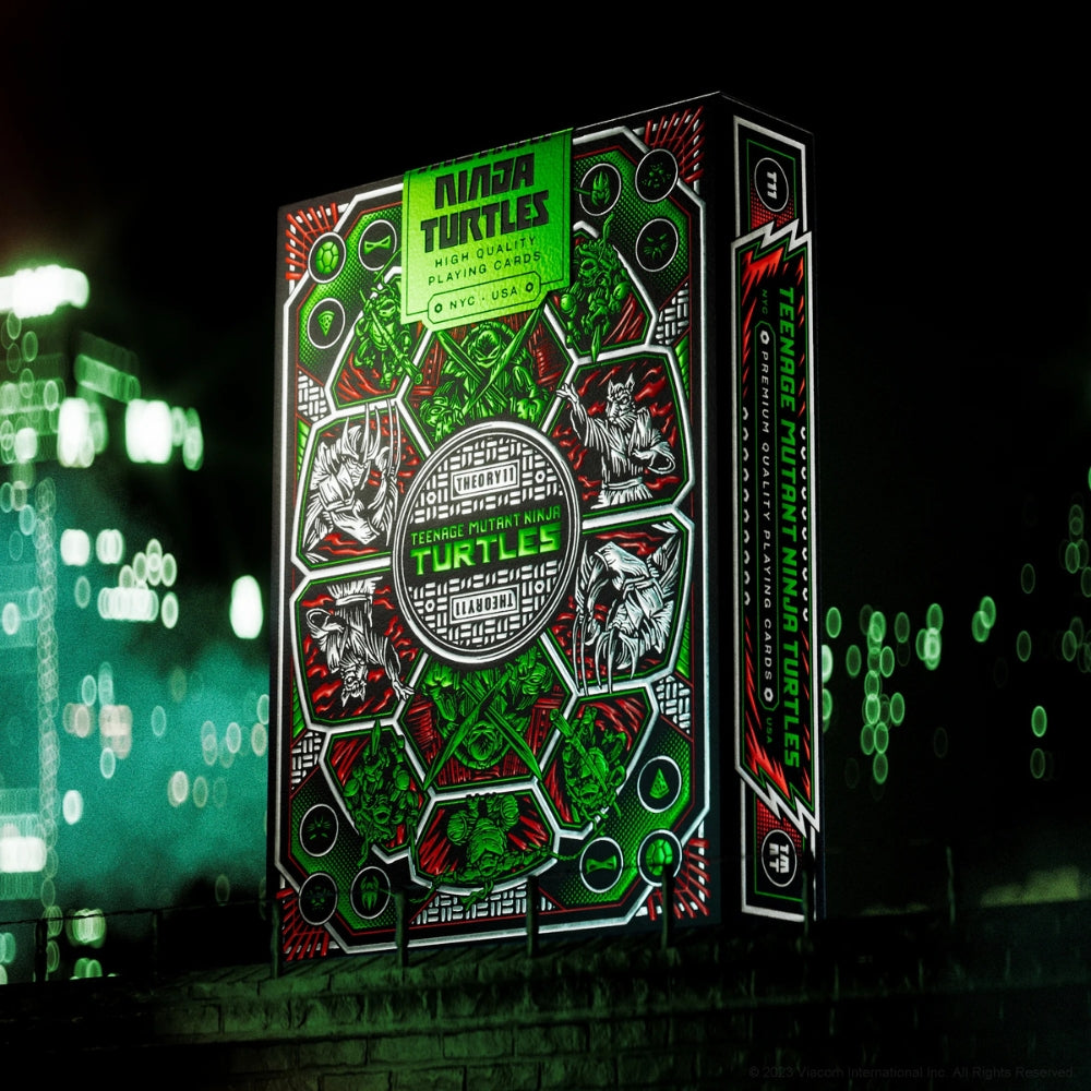 Deck of teenage mutant ninja turtles playing cards standing on top of a building in a busy city at night