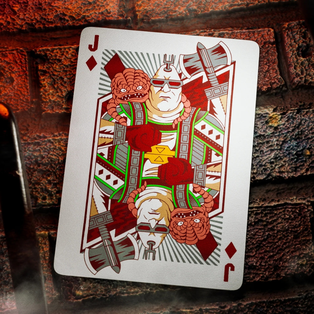 Jack of spades from a deck of teenage mutant ninja turtles playing cards laying against a brick wall