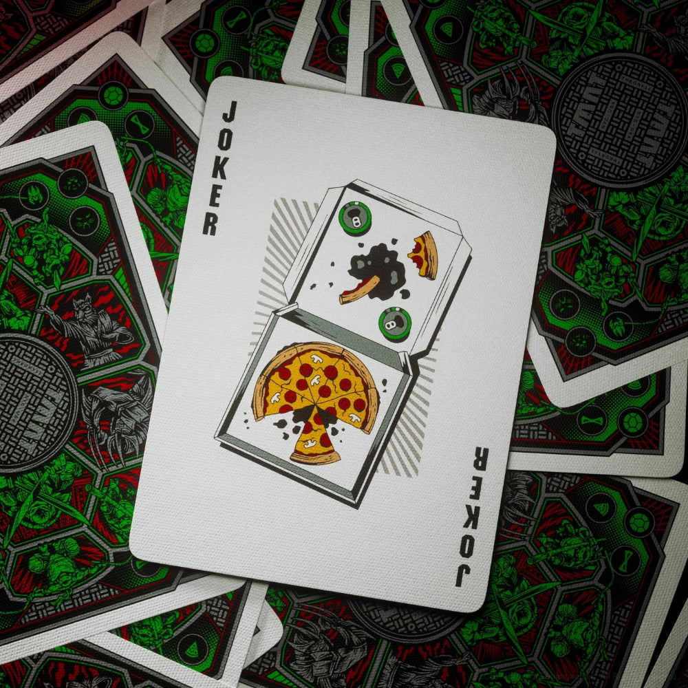Joker card from a deck of Teenage mutant ninja turtles (TMNT). The card is laying over a scattering of face down cards