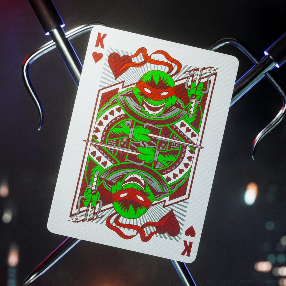 King of hearts from a deck of teenage mutant ninja turtles playing cards, with two Sai in the background