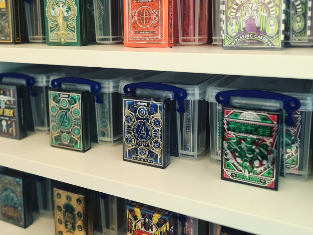 Playing cards lined up on a shelf