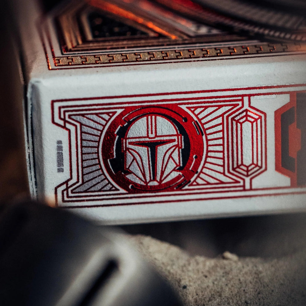 super close up photo of the side of a box of Mandalorian playing cards, featured in the shot is detail of the Mandalorian helmet 