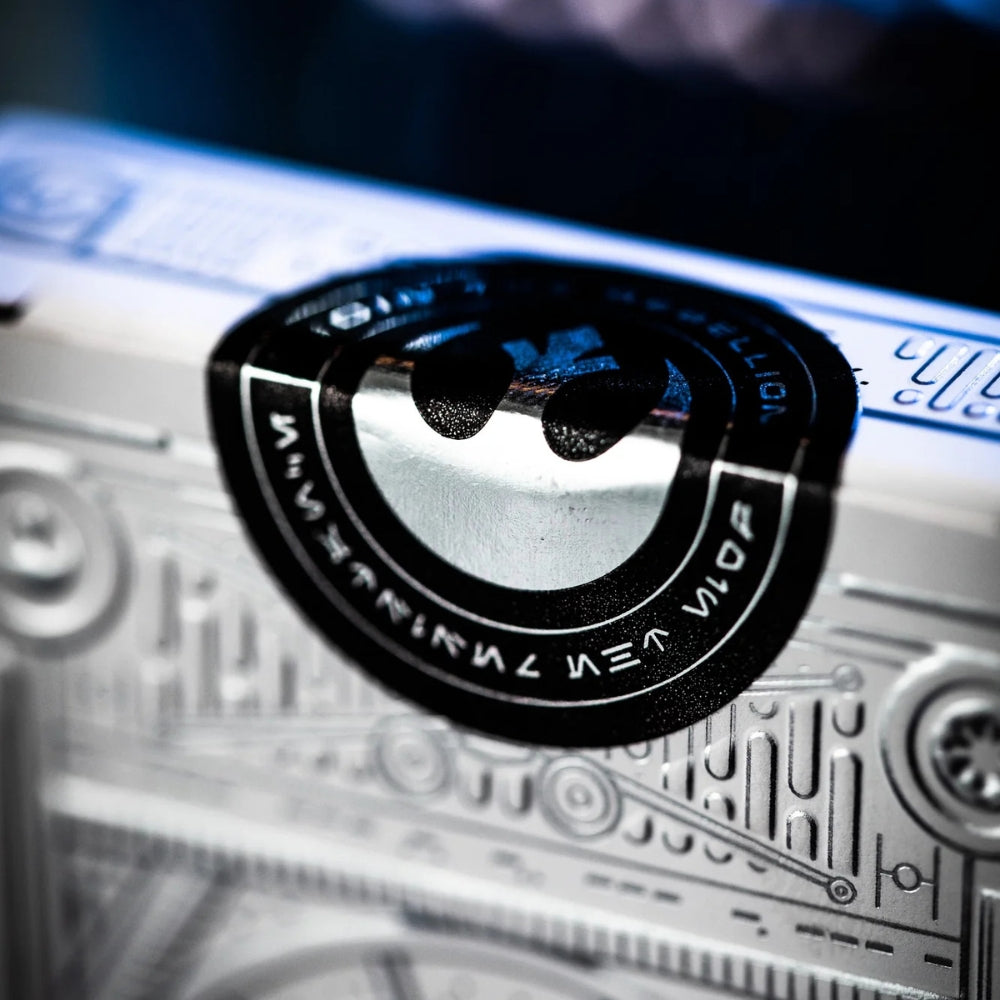 super close up image of the seal on a deck box of star wars playing cards.  The deck box is white and silver, and the seal is shiny black and silver.