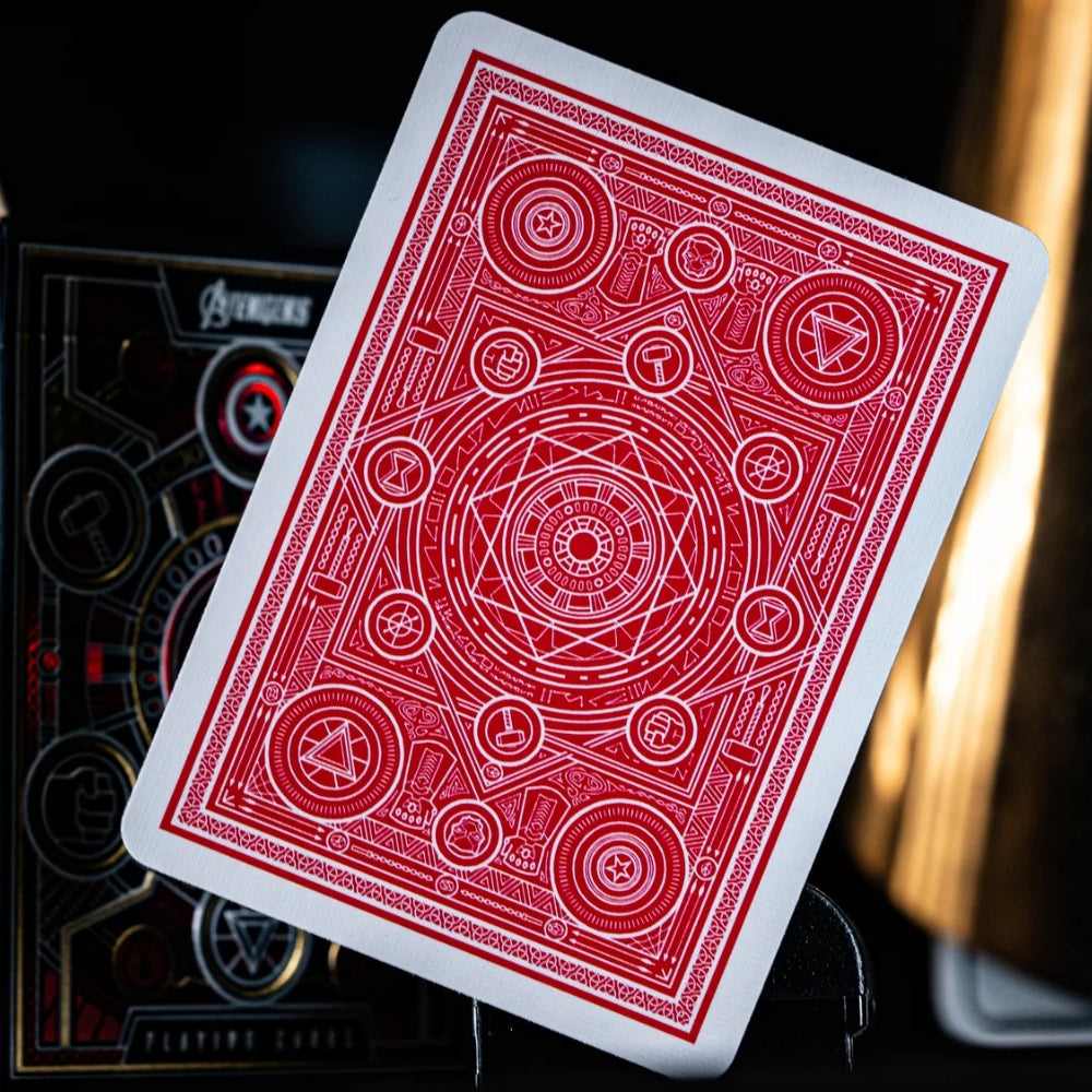 Back of a red avengers playing card, with a deck box in the background