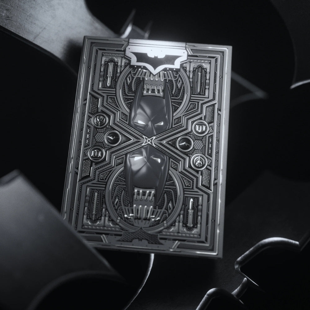 close up photo of the dark knight deck box, with batarangs floating around it.