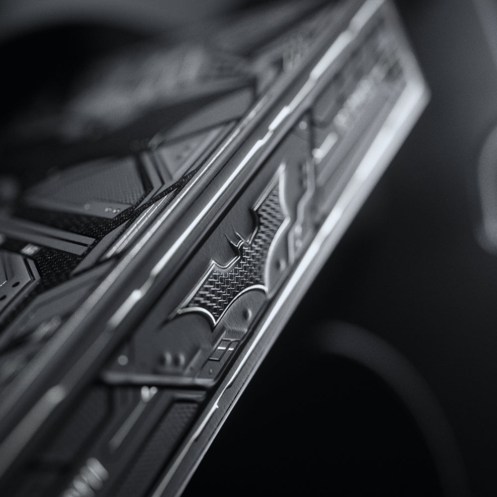 Super closeup photo of the side of the dark night playing cards deck box.  The focal point of the shot is the Batman symbol from the side of the box