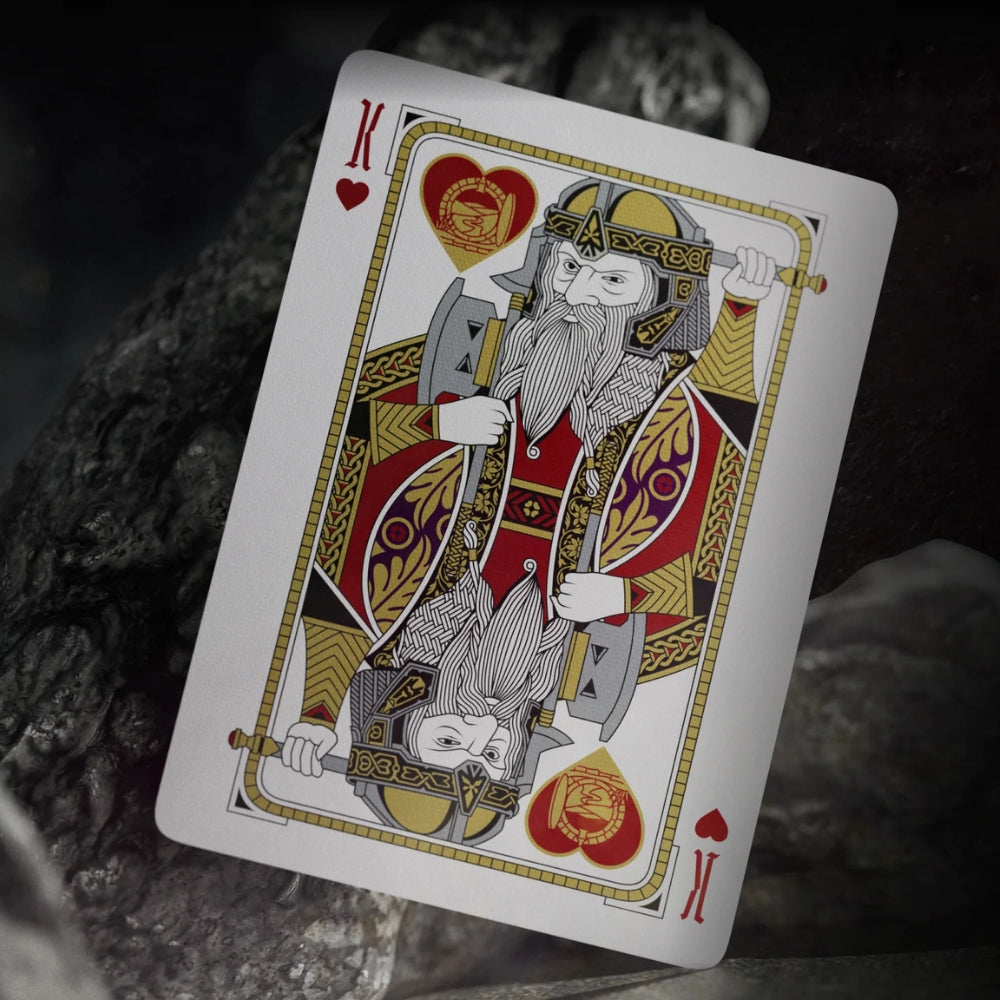 King of hearts card, leaning against a rock, the card is taken from a deck of lord of the rings playing cards