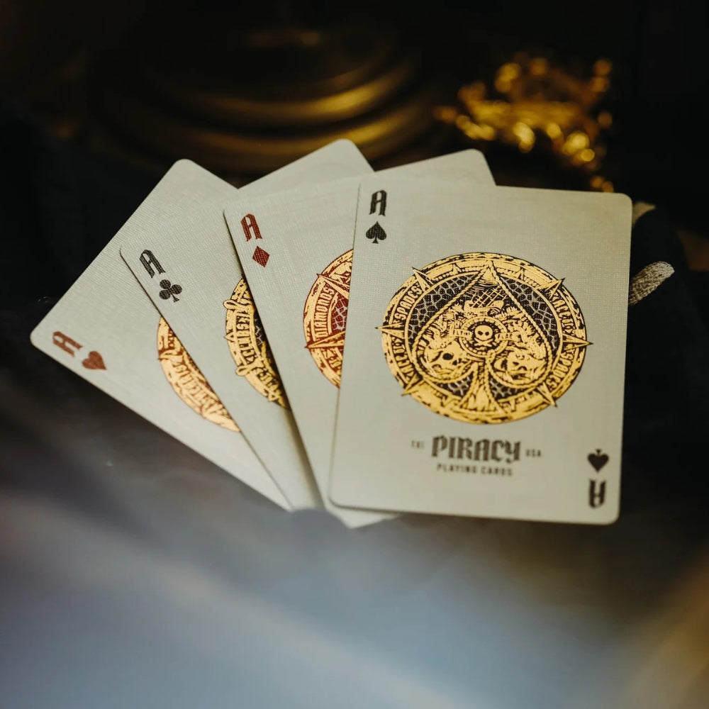 Four ace cards fanned on a desk, from the piracy playing cards deck