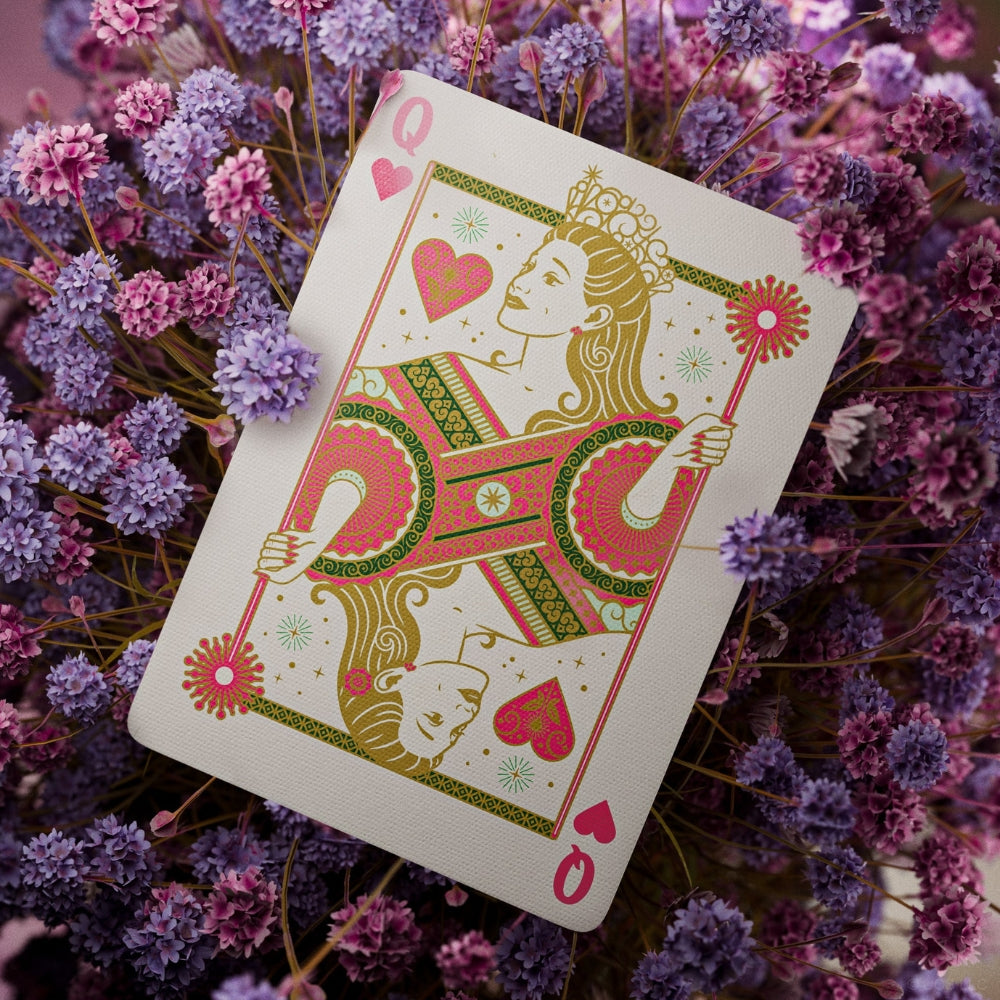 Queen of hearts playing card surrounded by purple hued flowers. Taken from a deck of wicked playing cards